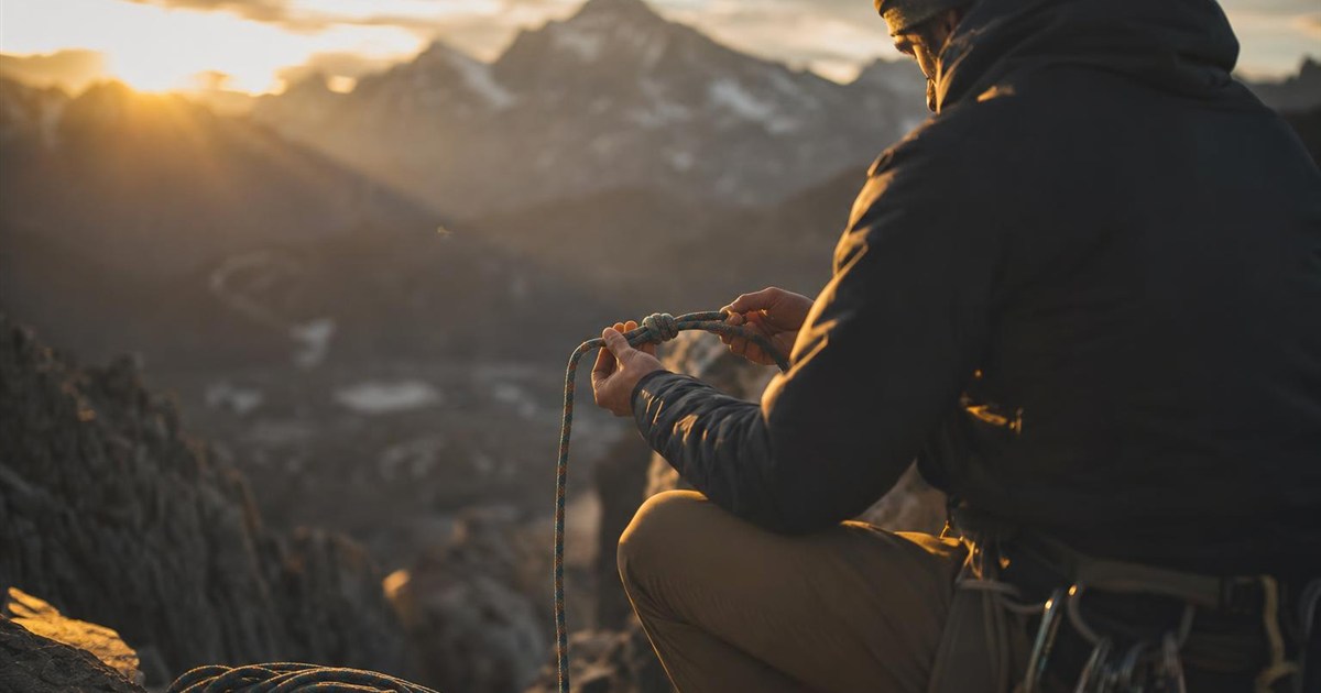 Climber practicing knots and technique before the real ascent, representing skill-building in advance
